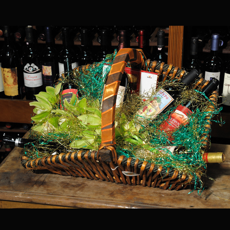 floral arrangement of flowers in a basket with wine and cokolate - CELL 24009