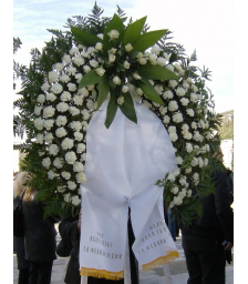 Funeral wreath with construction of white roses with tropical foliage and carnations - COND 39001